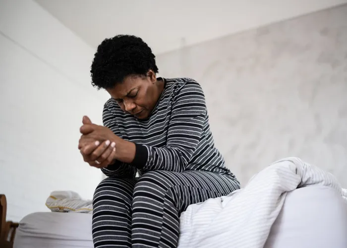 Mature woman feeling bad on bed at home