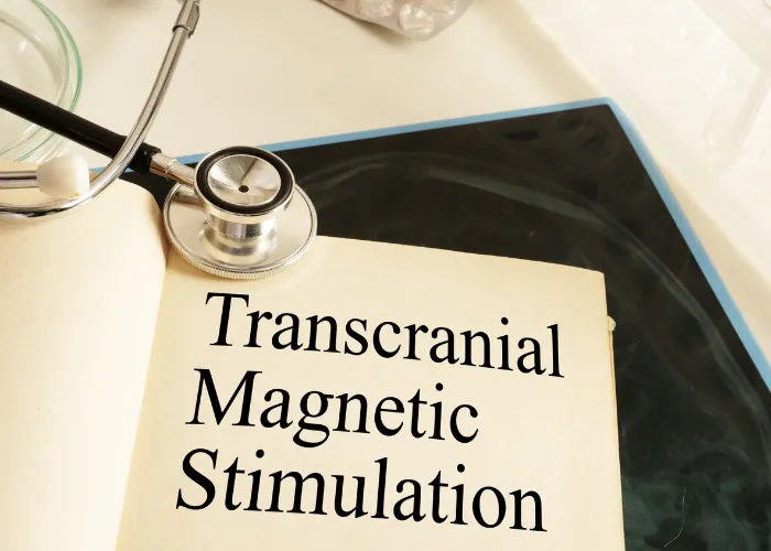 Transcranial Magnetic Stimulation TMS is shown on a photo using the text