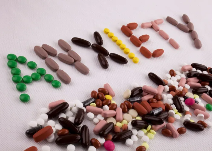 Hand writing text caption inspiration Medical care concept written with pills drugs capsule word anxiety On white isolated background with space