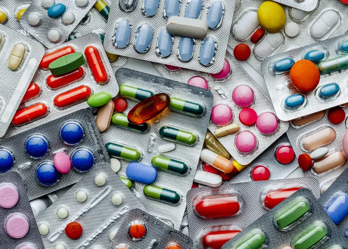 Health themes: Background of a large group of assorted capsules, pills and blisters. Drug abuse.