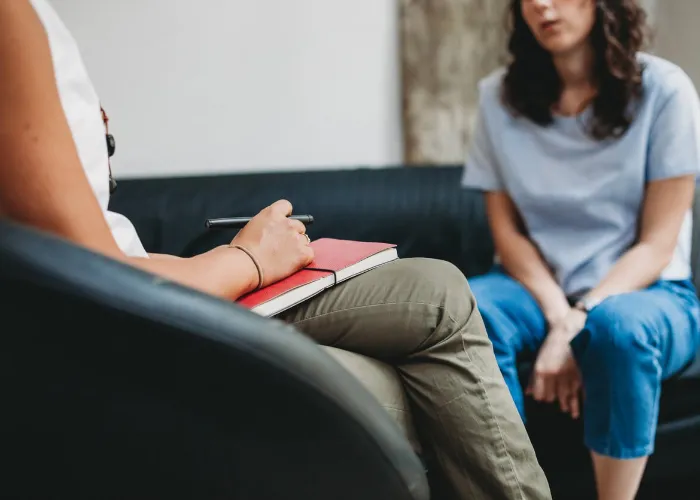 Psychotherapy session, woman talking to his psychologist in the studio